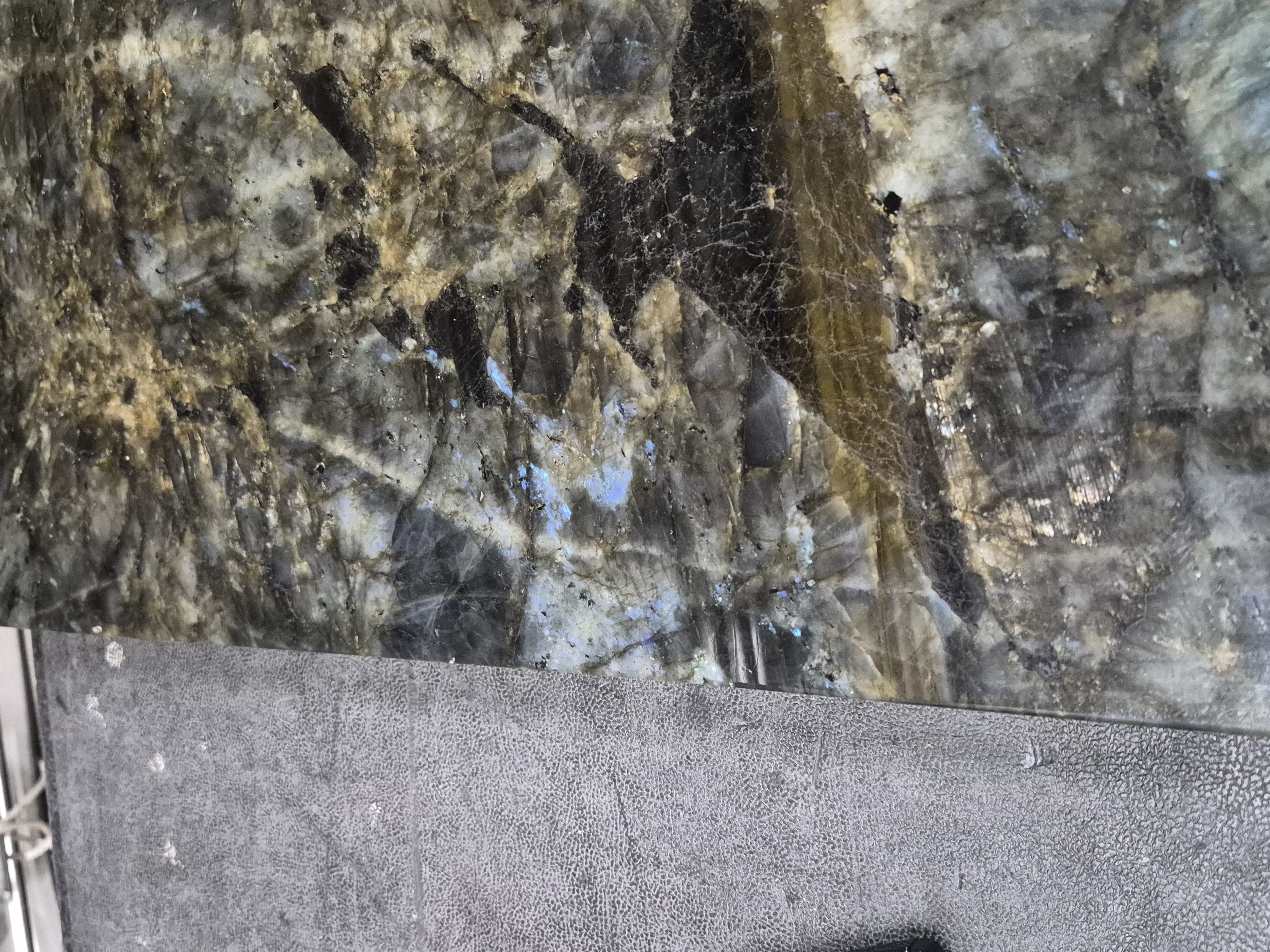 A labradorite slab, swirling brown and black