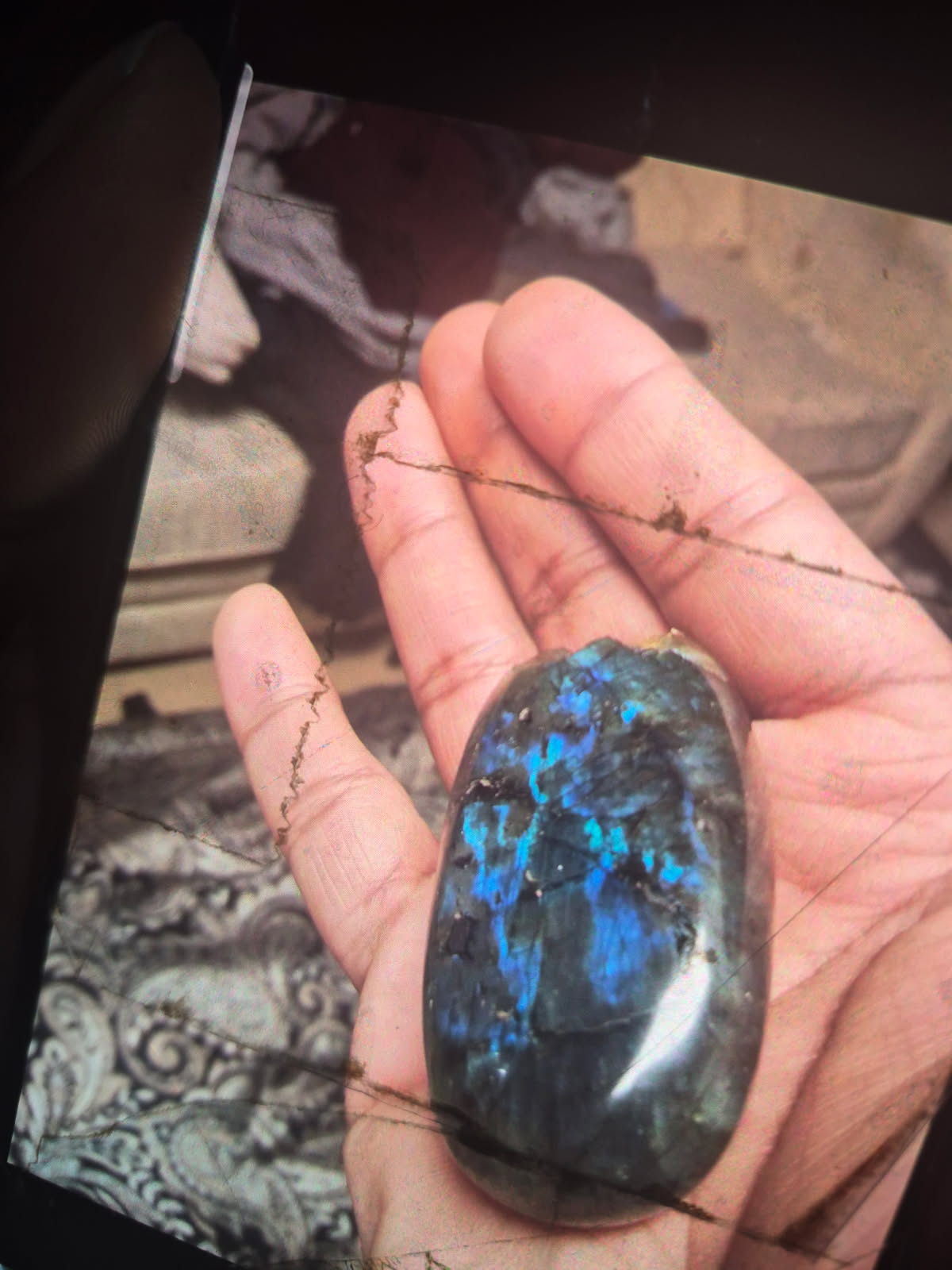 The oval labradorite in the palm