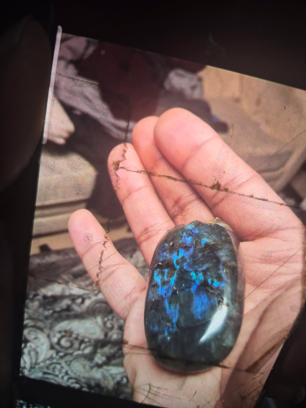 The labradorite held in an open hand
