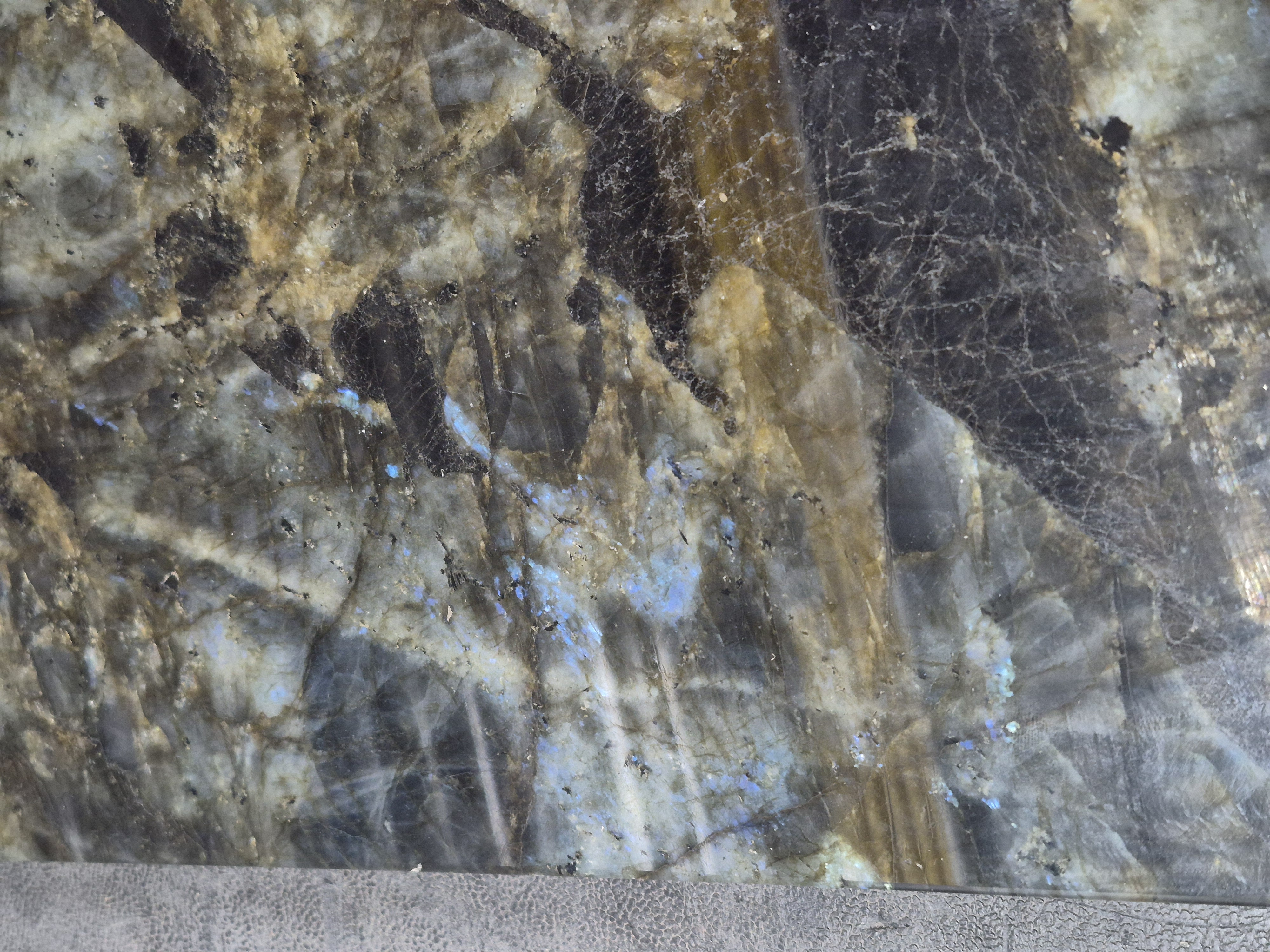 A labradorite slab with gold and grey streaks