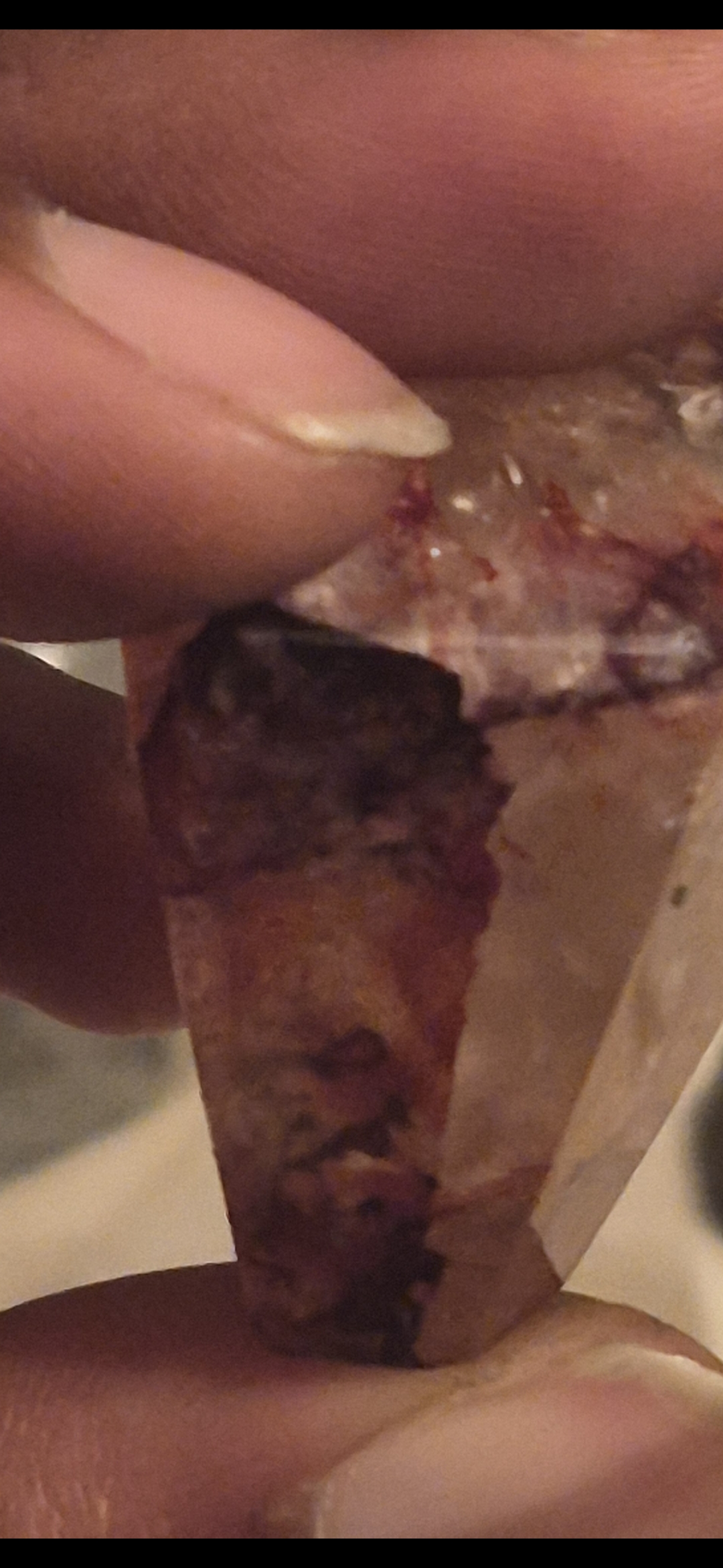 A translucent fragment with reddish brown inclusions